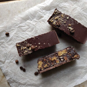 A photo of coffee and hazelnut tiffin on slightly scrunched parchment paper